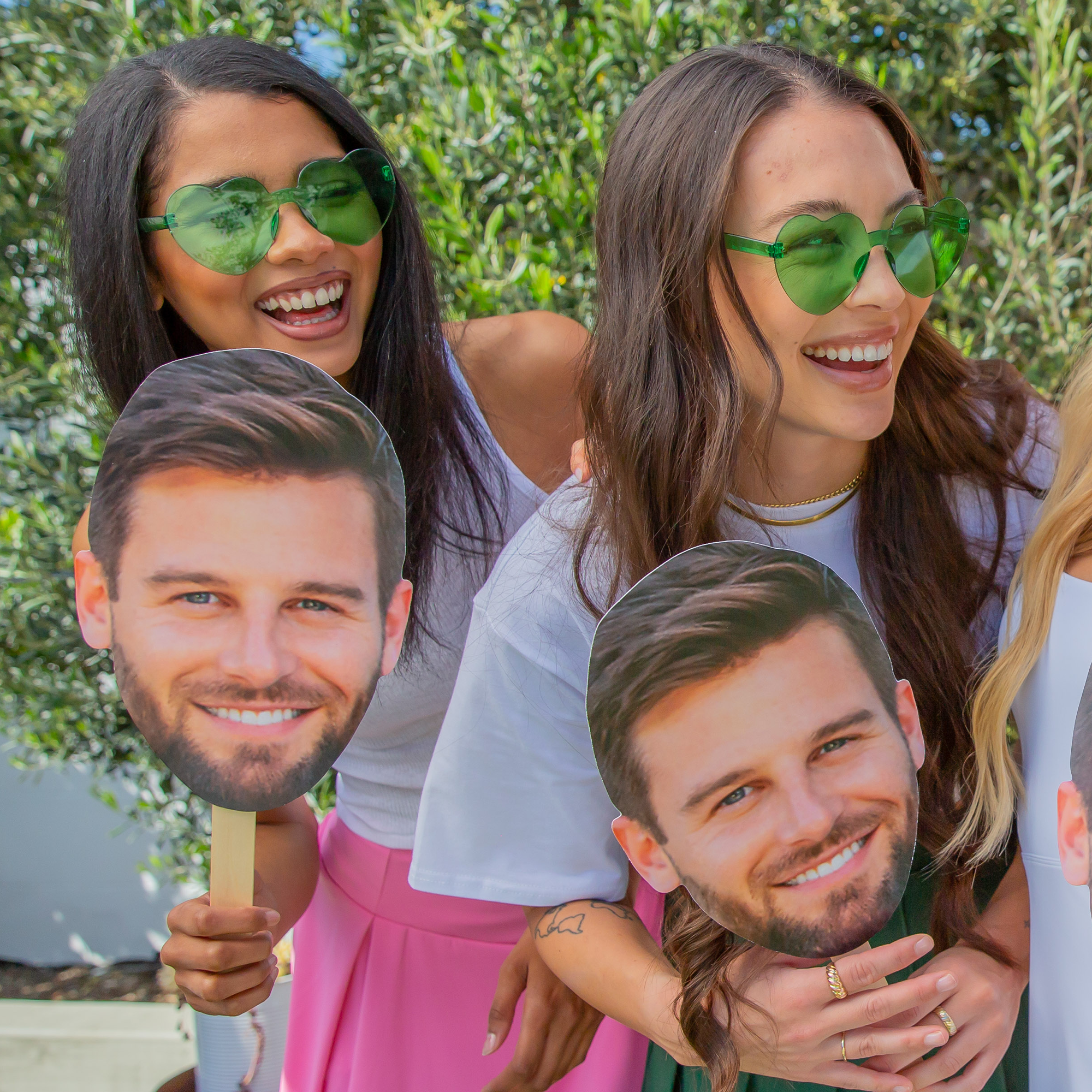 Girls holding a groom's face on a stick party photo from Sunkissed Party Co. for a bachelorette party.