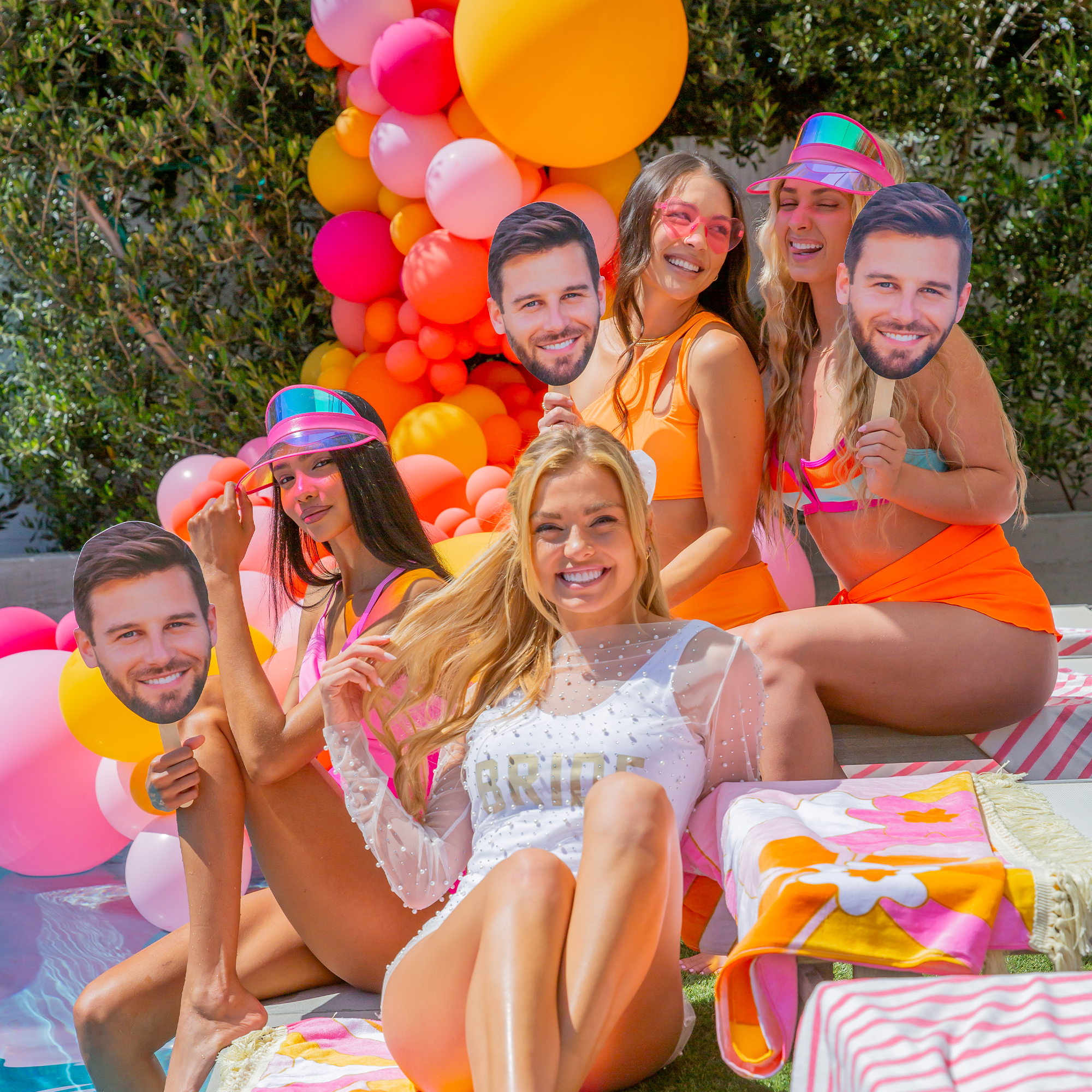 Bride at a pool bachelorette party holding a custom groom face-on-a-stick prop – fun, personalized photo-ready party favor for bachelorette celebrations