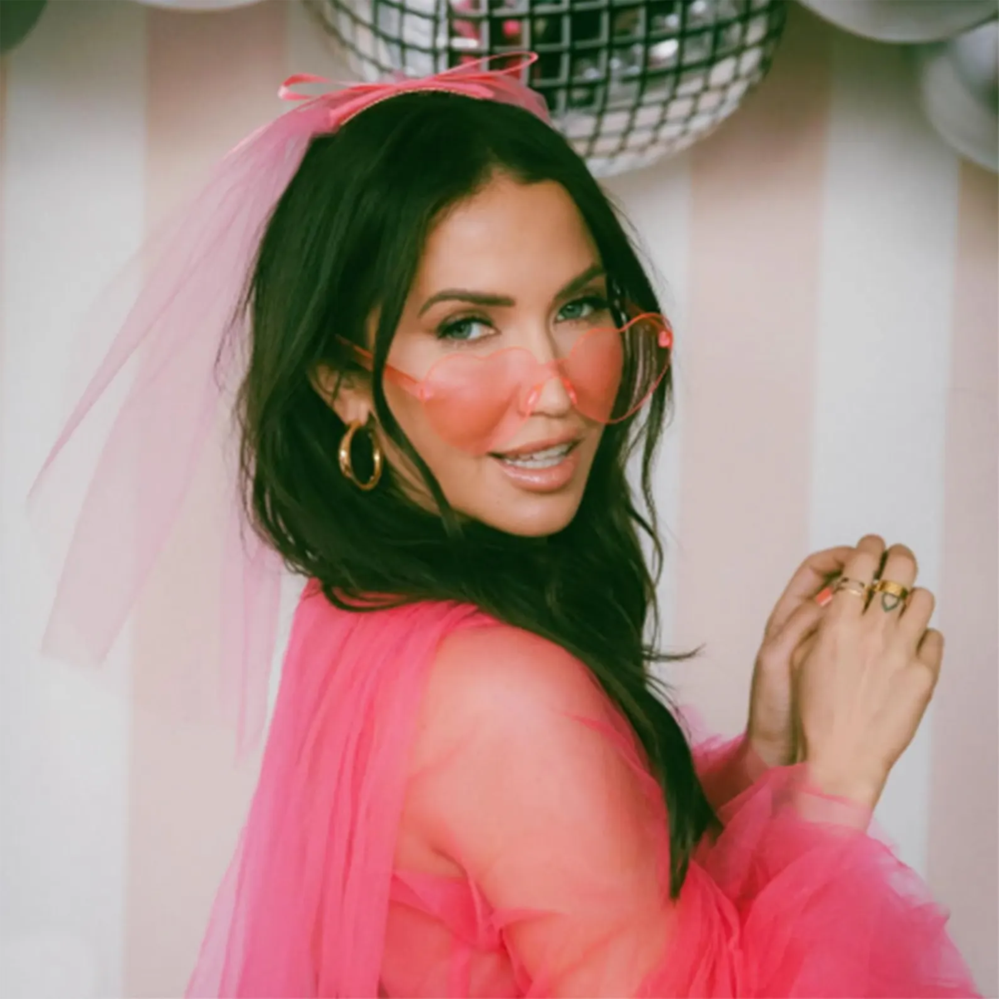 Pink Custom Name heart-shaped sunglasses on bride – stylish bachelorette party outfit accessories for all celebrations and girls’ trips.