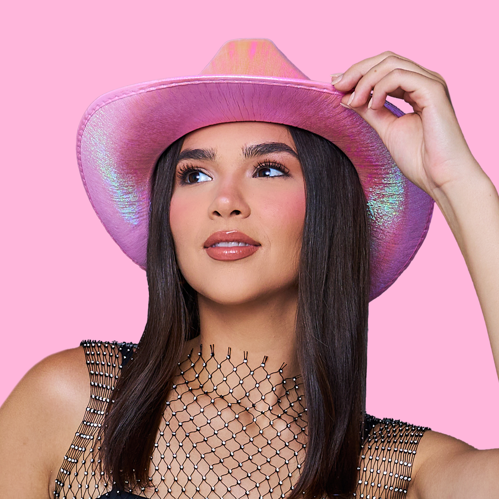 Bridesmaid wearing a pink metallic cowgirl hat—perfect party accessory for western, space cowgirl, disco girl bachelorette parties or music festival outfits.